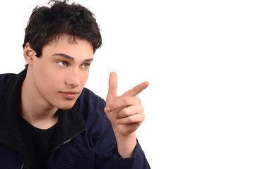  Young man smiling pointing to the side. Isolated on white.
