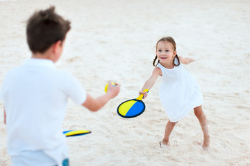 Kids playing beach tennis
