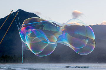 Man making large soap bubbles on beach