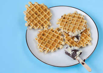 Plate of waffles on light blue background