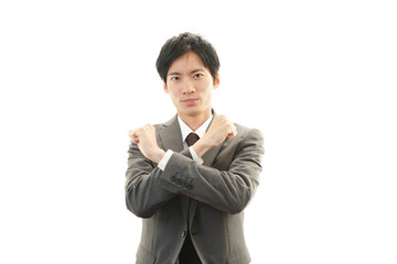 禁止の意思表示をするビジネスマン