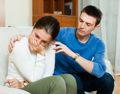 crying woman has problem, man consoling her
