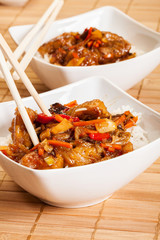 Sweet and sour pork and rice in a bowl 