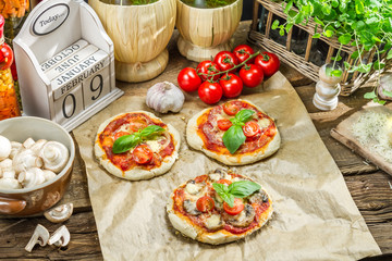 Fresh ingredients for a mini pizza with mushrooms