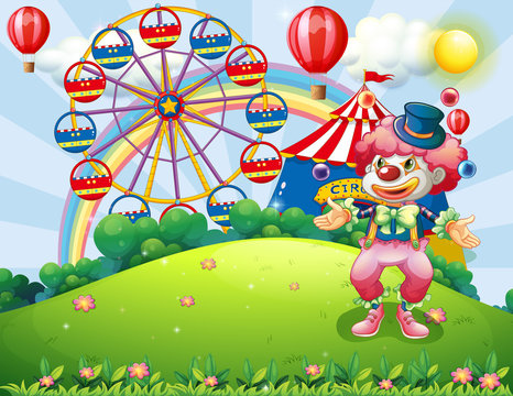A clown juggling at the hilltop across the carnival