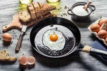 Fotobehang Spiegeleieren Preparing for frying eggs on a pan