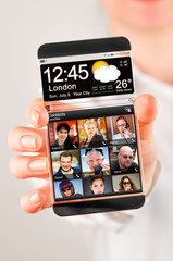 Smartphone with transparent screen in human hands.