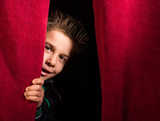 Child appearing beneath the curtain - 61534843