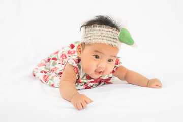 Cute baby smiling girl with rose headband