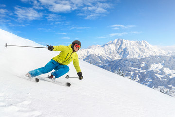Male skier with mountains