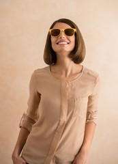 Portrait of beautiful smiling young woman wearing sunglasses