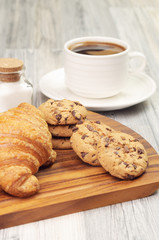 Some croissants and cookies with coffee