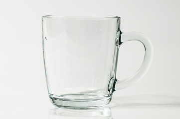 An isolated picture of a transparent glass mug