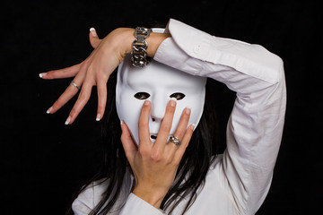 Beautiful woman hiding behind a mask