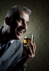 Vintage businessman holding a glass of whisky