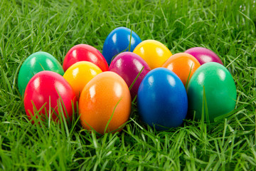 Fototapeta na wymiar easter eggs in busket on green gras isolated
