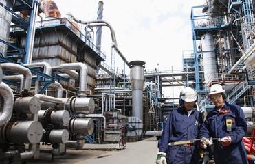 main refinery station with two fuel and gas workers