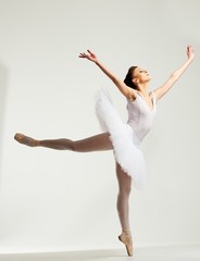 Young ballerina dancer in tutu showing her techniques