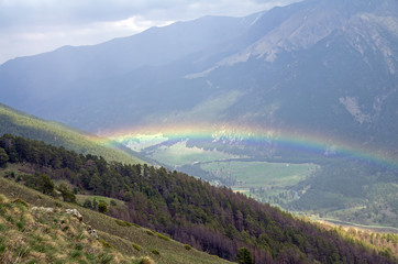 Rainbow in a mountain gorge.