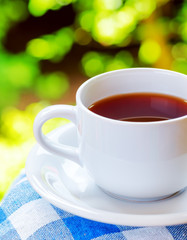 Cup of tea on nature background