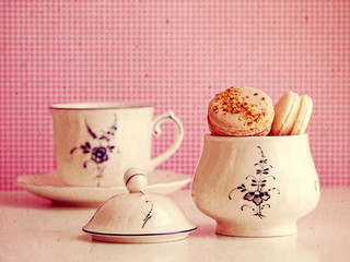 Macaroons in sugar bowl and cup. Retro look.