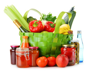 Green shopping bag with groceries isolated on white
