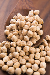 dried white chickpeas ceci on the wooden spoon