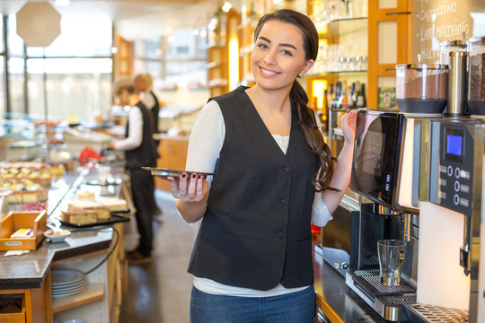 Waitress in café or restaurant and coffee machine