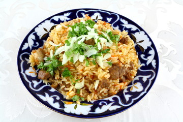 Cooked oriental risotto, meat with rice, closeup