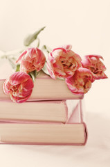 pink tulips on the books