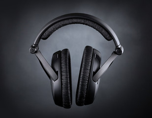 Fototapeta na wymiar Modern headphones over black background