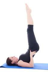 Fototapeta premium young beautiful sporty girl doing legs up exercise isolated on w