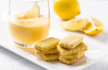 Stack of cookies and lemon curd in glass