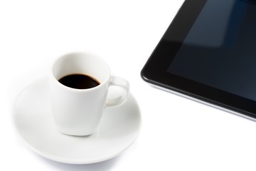 Fototapeta na wymiar cup of coffee near a tablet, concept of new technology