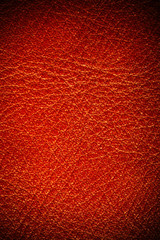 Red textured leather grunge background closeup