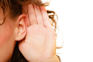 Part of head woman with hand to ear listening