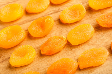 Dried apricots set on wooden table background.