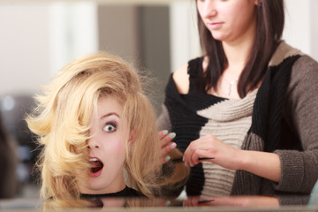 Fototapeta premium Surprised shocked female client blond girl in hairdressing salon
