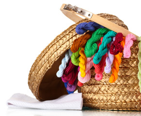 bright threads for needlework and fabric in a wicker basket