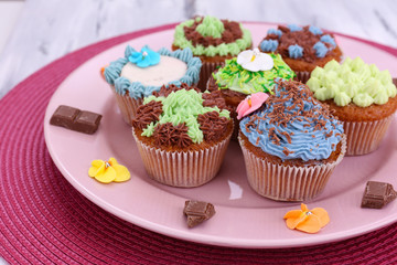 Tasty cupcakes with butter cream,