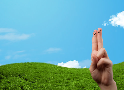 Cheerful finger smileys with landscape scenery at the background