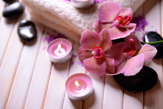 Still life with beautiful blooming orchid flower, towel and spa