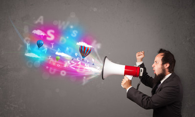 Man shouting into megaphone and abstract text and balloons come