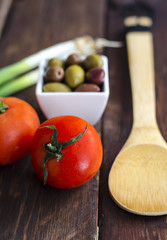 Bowl with olives, tomatoes and green onion