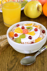 Delicious oatmeal with fruit in bowl on table close-up