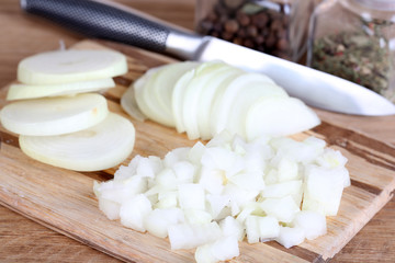Fototapeta na wymiar Cut onion on cutting board on wooden background