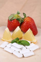 Chewing gums with fruit taste,   on color wooden background