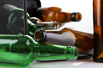 Glass bottles in recycling bin close up