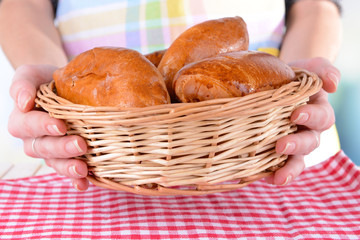 Fresh baked pasties with berries in wicker basket close-up