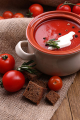 Tasty tomato soup on wooden table